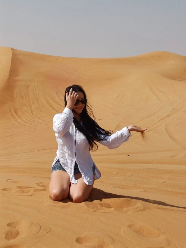 Tourists enjoying morning sandboarding in the UAE desert